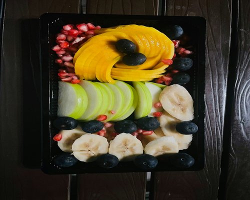 Fresh healthy fruits and yoga mat setup